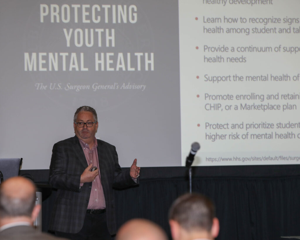 JP Guilbault with slideshow that says "Protecting Youth Mental Health"